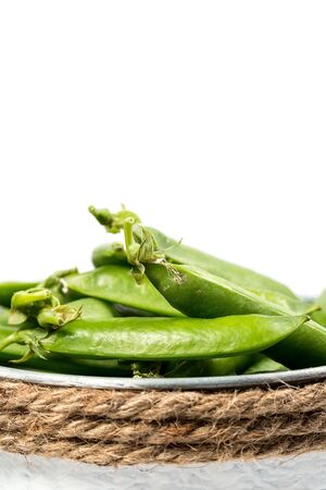 Ripe green peas on a white background, after assembly on the farmの写真素材