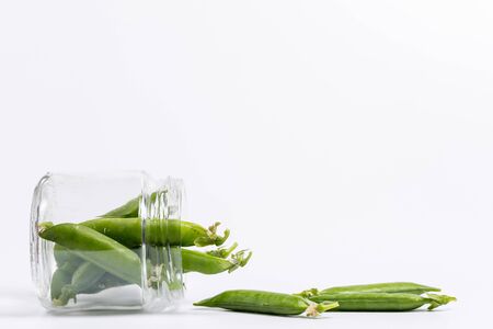 Ripe green peas on a white background, after assembly on the farmの写真素材