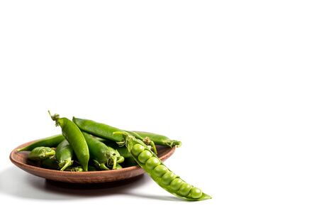 Ripe green peas on a white background, after assembly on the farmの写真素材