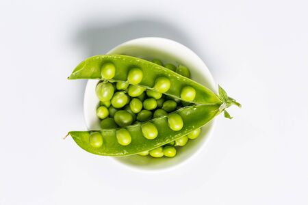 Ripe green peas on a white background, after assembly on the farmの写真素材