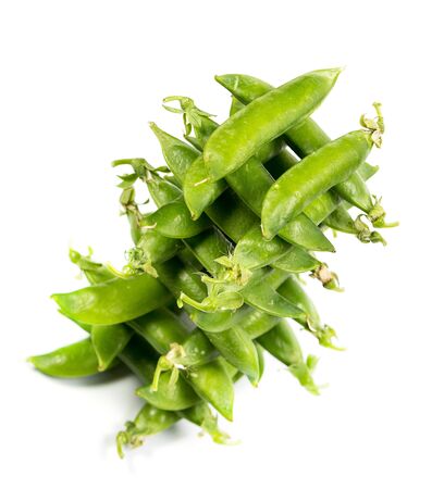 Ripe green peas on a white background, after assembly on the farmの写真素材