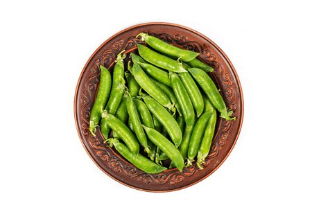 Ripe green peas on a white background, after assembly on the farmの写真素材
