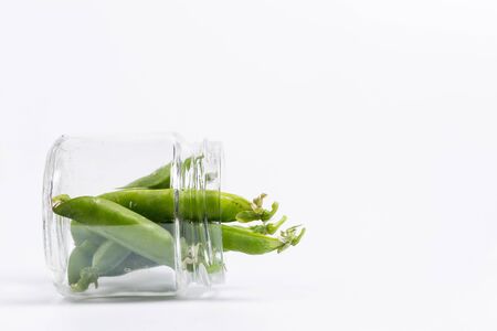 Ripe green peas on a white background, after assembly on the farmの写真素材