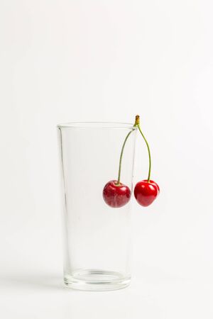 Ripe, red, sweet cherries on a white backgroundの写真素材