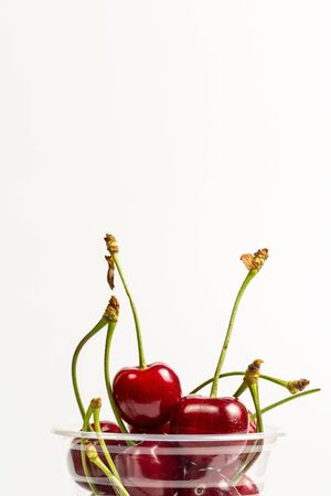 Ripe, red, sweet cherries on a white backgroundの写真素材