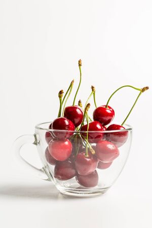 Ripe, red, sweet cherries on a white backgroundの写真素材