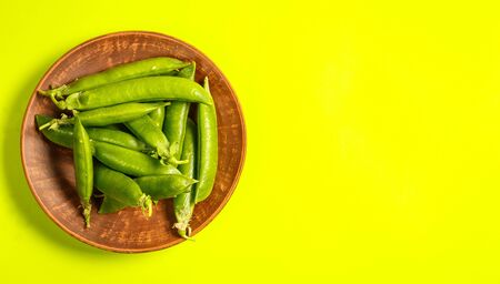 Ripe green peas on a green backgroundの写真素材
