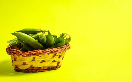 Ripe green peas on a green backgroundの写真素材