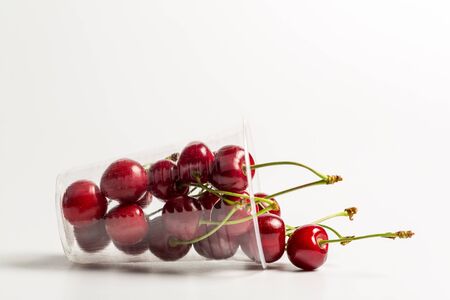 Ripe, red, sweet cherries on a white background