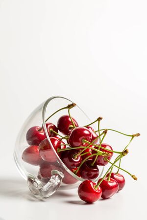 Ripe, red, sweet cherries on a white backgroundの写真素材