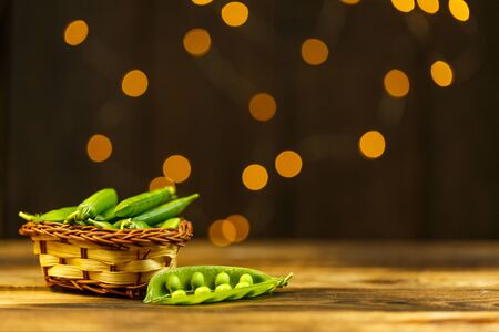 Ripe peas on a wooden table, beautiful bokehの写真素材
