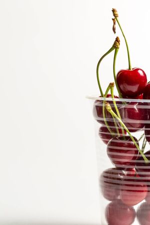 Ripe, red, sweet cherries on a white backgroundの写真素材