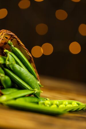 Ripe peas on a wooden table, beautiful bokehの写真素材