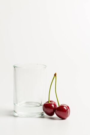 Ripe, red, sweet cherries on a white backgroundの写真素材