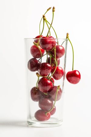 Ripe, red, sweet cherries on a white backgroundの写真素材