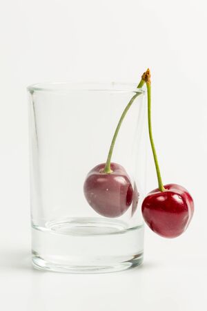 Ripe, red, sweet cherries on a white backgroundの写真素材