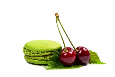 Tasty macaroon cookies and ripe raspberries on a white backgroundの写真素材