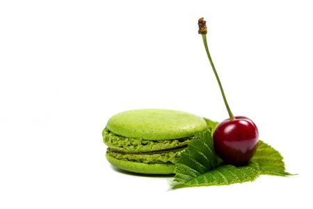 Tasty macaroon cookies and ripe raspberries on a white backgroundの写真素材