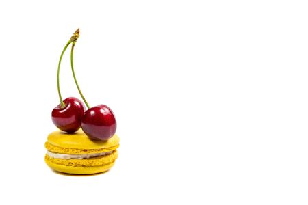 Tasty macaroon cookies and ripe raspberries on a white backgroundの写真素材
