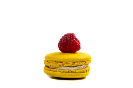 Tasty macaroon cookies and ripe raspberries on a white backgroundの写真素材