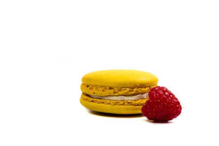 Tasty macaroon cookies and ripe raspberries on a white backgroundの写真素材