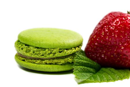 Tasty macaroon and strawberry cookies on a white backgroundの写真素材