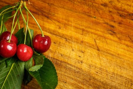 Sour red cherry on a wooden brown backgroundの写真素材