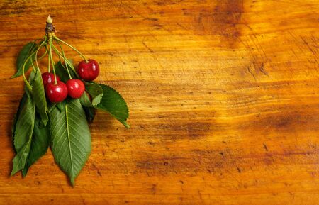 Sour red cherry on a wooden brown backgroundの写真素材