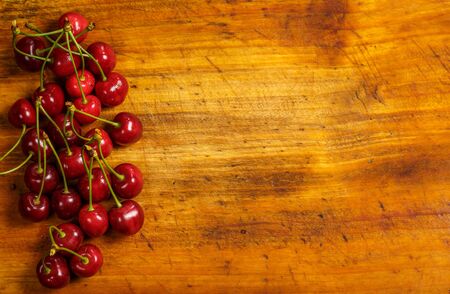 Sour red cherry on a wooden brown backgroundの写真素材