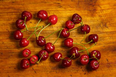Sour red cherry on a wooden brown backgroundの写真素材
