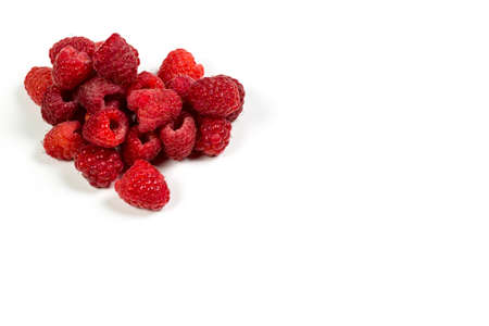 Fresh and red raspberries with vitamins on a white backgroundの写真素材