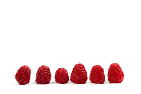 Fresh and red raspberries with vitamins on a white backgroundの写真素材