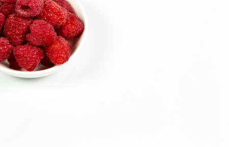Fresh and red raspberries with vitamins on a white backgroundの写真素材