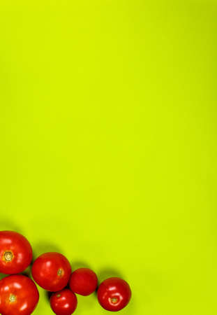 Ripe red tomatoes for salad on a green backgroundの写真素材