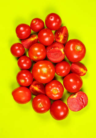 Ripe red tomatoes for salad on a green backgroundの写真素材
