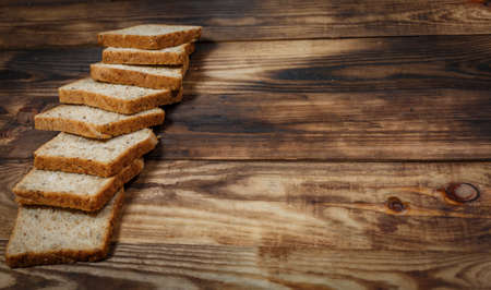 Sliced fresh gluten-free bread on wooden surface
