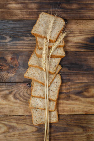 Sliced fresh gluten-free bread on wooden surface