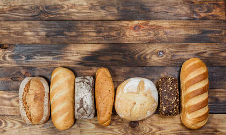 Sliced fresh gluten-free bread on wooden surface