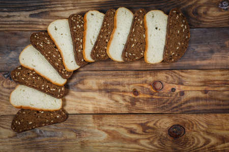 Sliced fresh gluten-free bread on wooden surface