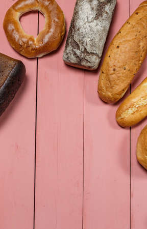 Assorted loaves of fresh gluten free bread on pink backgroundの写真素材