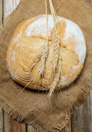 Gluten-free fresh bread of different colors and shapes on wooden surfaceの写真素材
