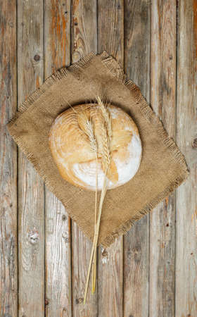 Gluten-free fresh bread of different colors and shapes on wooden surfaceの写真素材