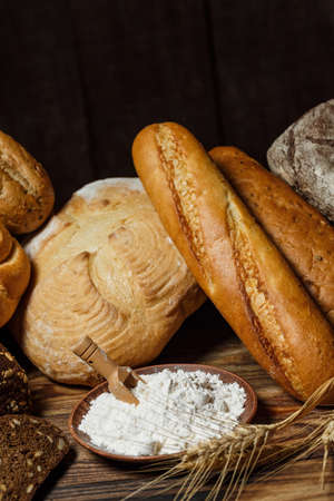 Fresh assorted loaves of gluten-free bread on wooden tableの写真素材