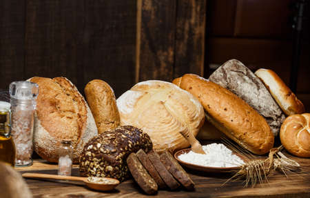 Fresh assorted loaves of gluten-free bread on wooden tableの写真素材