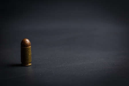 9mm bullet for pistol and self-defense on black background