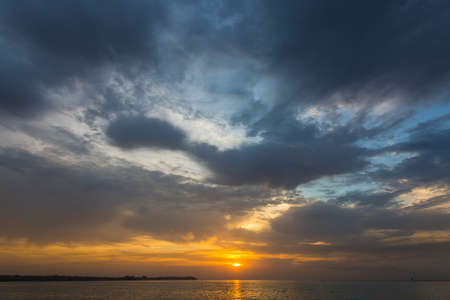 Dramatic and romantic sunrise in autumn, clouds and storm cloudsの写真素材