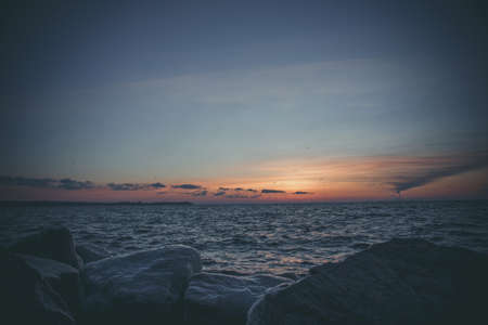Beautiful orange sunrise near the bank of the big riverの写真素材
