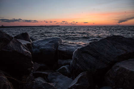 Beautiful orange sunrise near the bank of the big riverの写真素材