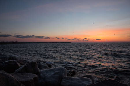 Beautiful orange sunrise near the bank of the big riverの写真素材