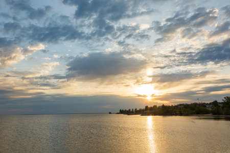 Beautiful orange sunset by the river bankの写真素材